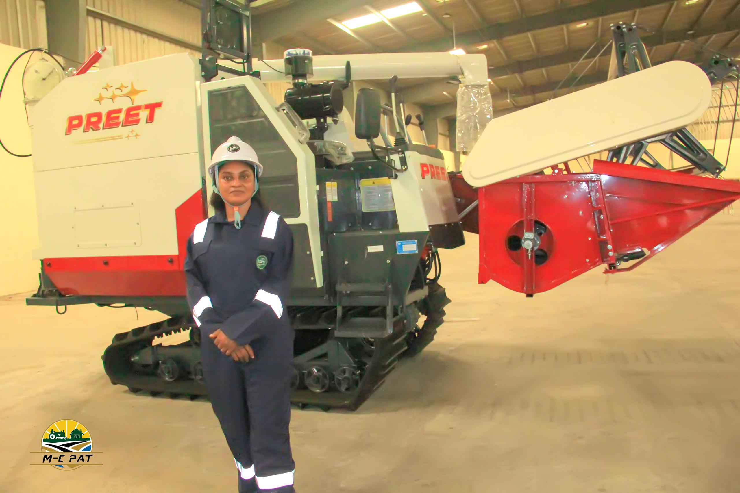 Mela-Chiyoma Pat team member with a PREET combine harvester